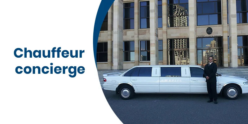 A chauffeur in a suit stands next to a white stretch limousine parked in front of a grand building with tall windows, embodying the essence of chauffeur concierge services. The words Chauffeur Concierge are elegantly displayed to the left.